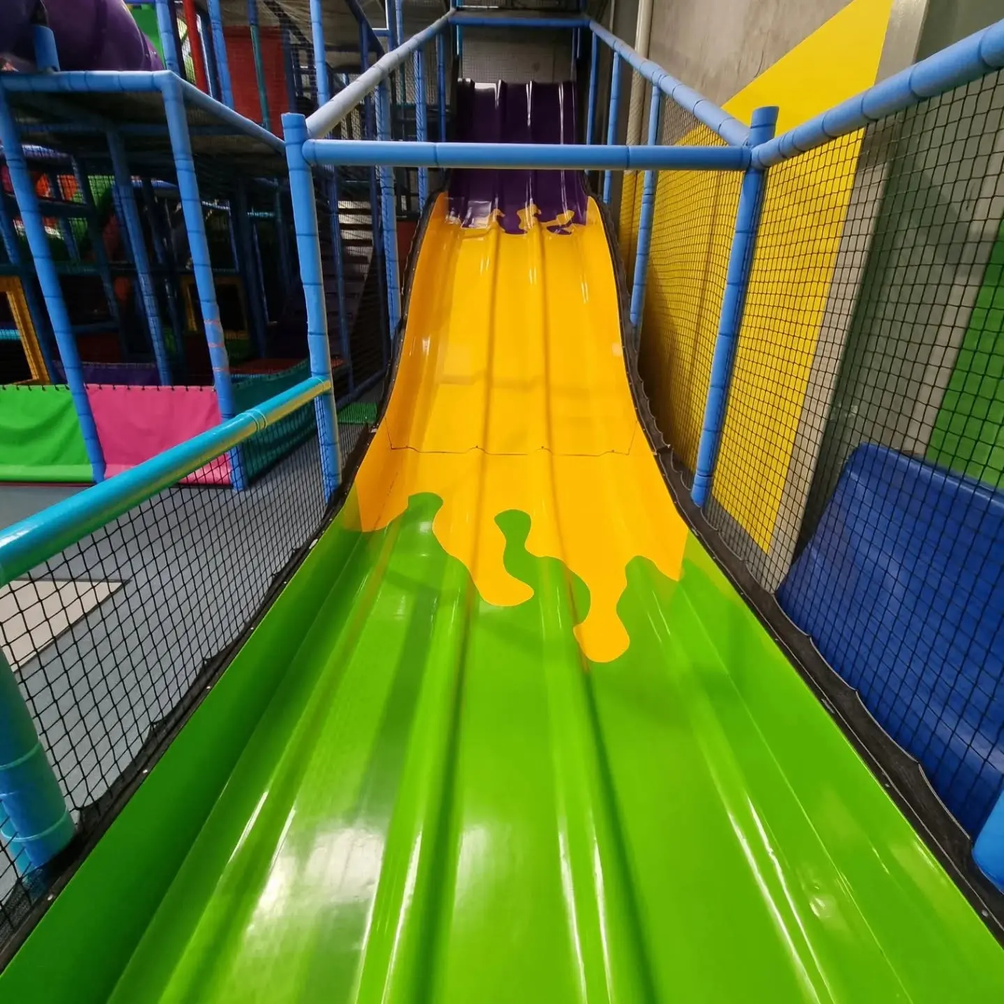 Colourful enclosed slide inside the indoor play equipment at Meerkat Manner, Ocean Grove