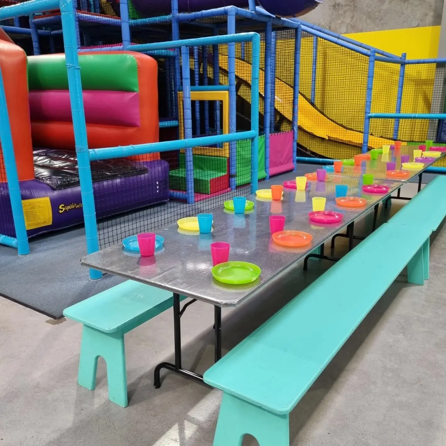 Party table set up with plates and cups for a kids birthday party at Meerkat Manner, Ocean Grove